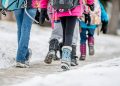 kids walking to school together in winter