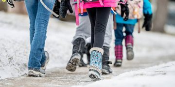kids walking to school together in winter