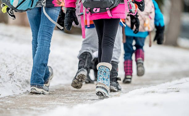 kids walking to school together in winter